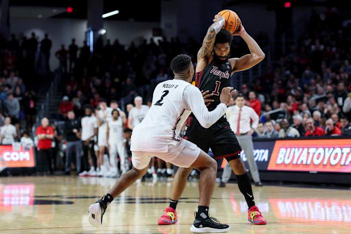 Feb 22, 2023; Cincinnati, Ohio, USA; Temple Owls guard Damian Dunn (1) controls the ball against Cincinnati Bearcats guard Landers Nolley II (2) in overtime at Fifth Third Arena. Mandatory Credit: Aaron Doster-USA TODAY Sports
